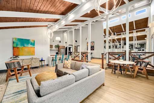 a living room with a couch and tables and chairs
