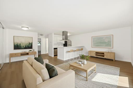 A living room with a tan couch and a coffee table.