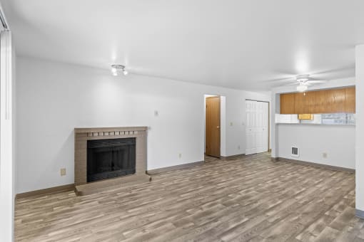 a living room with a fireplace and a wooden floor