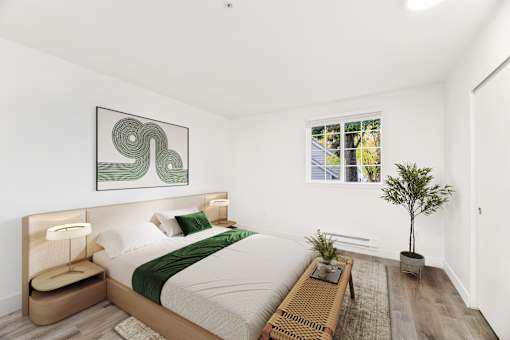 A bedroom with a large bed and a green abstract painting above it.