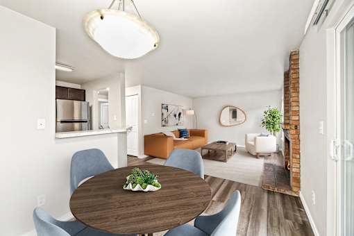 A modern dining room with a wooden table and blue chairs.