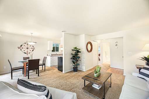 A living room with a white couch and a coffee table.