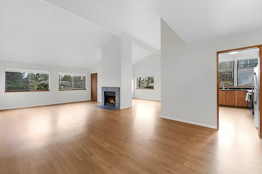A room with a fireplace and a large mirror on the wall.