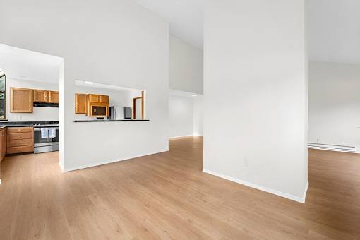 A kitchen with wooden floors and white walls.
