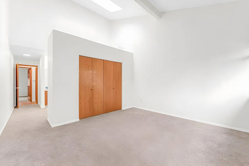 A room with a brown door and a white wall.