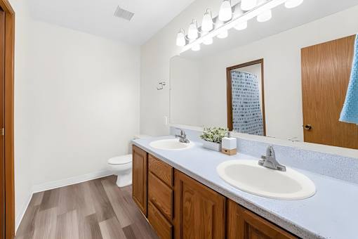 A bathroom with a white sink and a mirror.