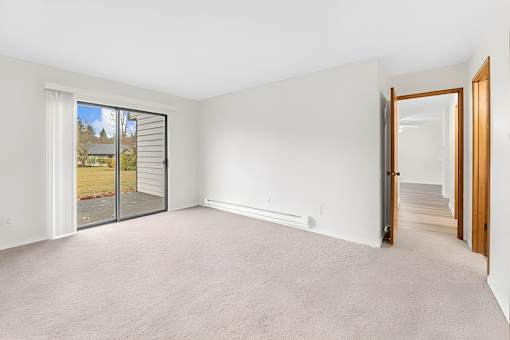A room with a sliding glass door leading outside.