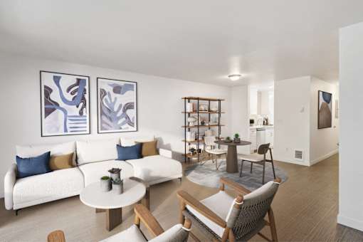 A living room with a white couch and a coffee table.