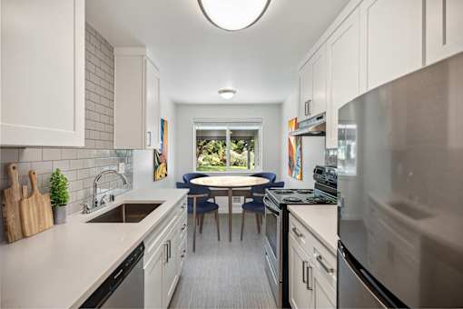 A modern kitchen with a large island and stainless steel appliances.