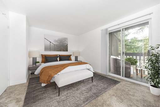 A bedroom with a large bed and a painting on the wall.