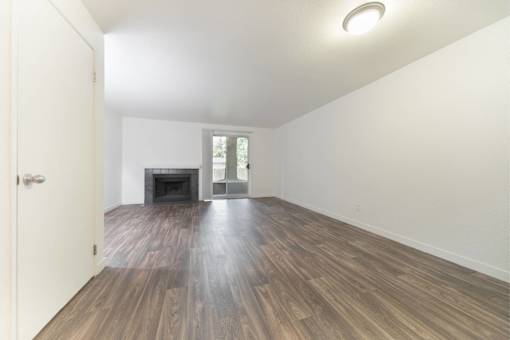 A room with wooden floors and a fireplace.