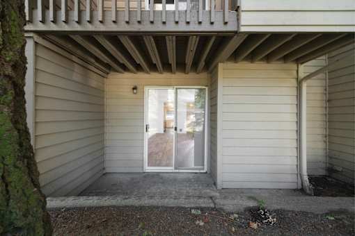 A small white house with a door and a window.