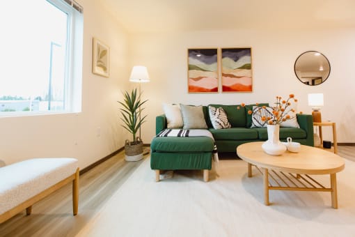 a living room with a green couch and a table
