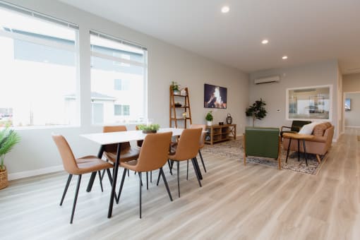 a living room and dining room with a table and chairs