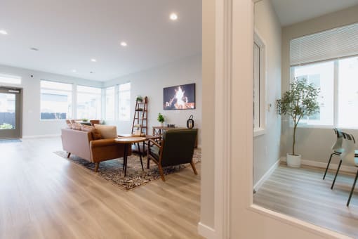 a living room and dining room with a table and chairs and a fireplace