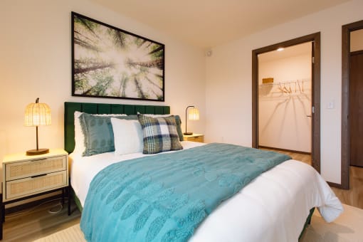 a bedroom with a bed and a door to a closet