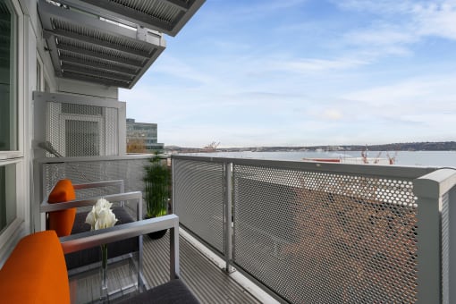 a balcony with a view of a body of water