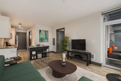 a living room with white walls and a green couch