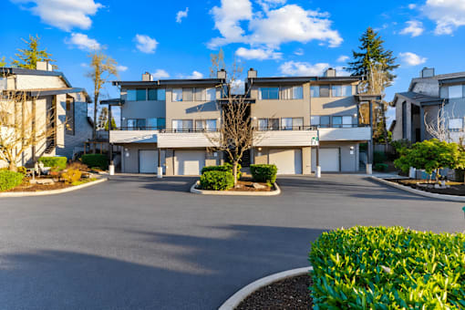 A large building with a driveway in front of it.