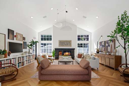 A living room with a fireplace, a couch, and a chair.