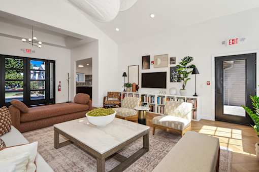 A living room with a couch, chairs, and a coffee table.