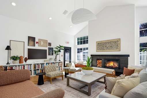 A living room with a fireplace and a television.