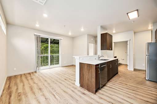 A kitchen with wooden floors and white walls.