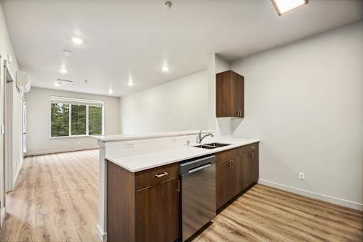 A kitchen with wooden cabinets and a stainless steel dishwasher.