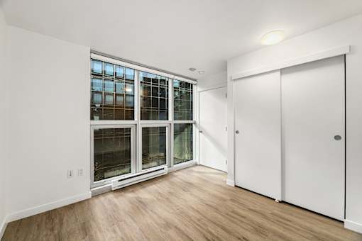 A room with a white door and a window with a white frame.