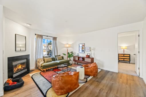 a living room with a fireplace and leather furniture