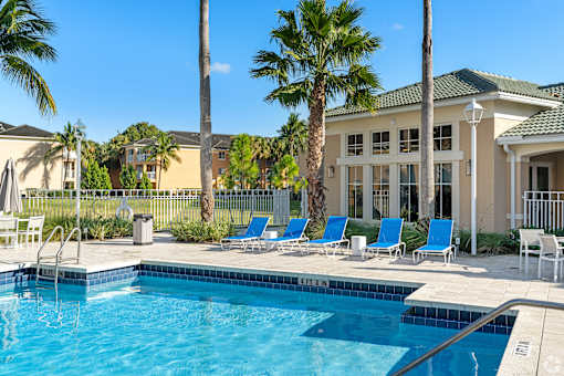 A pool with a building behind it.