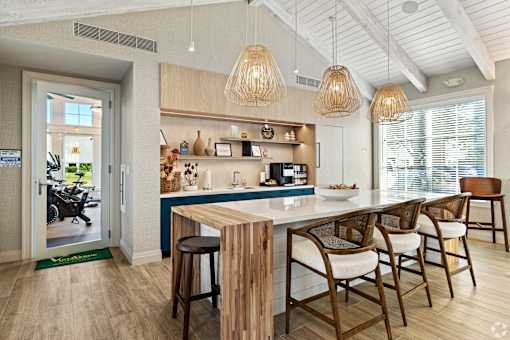 A kitchen with a bar area and a dining table.