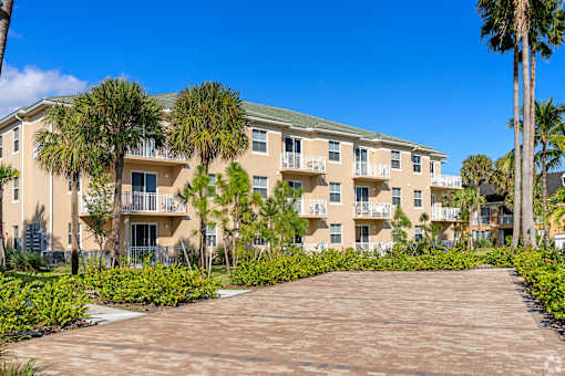 A large apartment complex with a driveway in front.