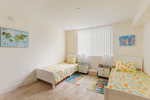 a bedroom with two beds and a window