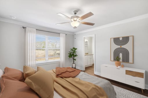 a bedroom with a bed and a ceiling fan