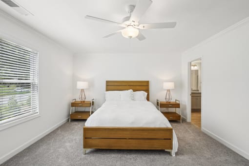 a bedroom with a large bed and a ceiling fan
