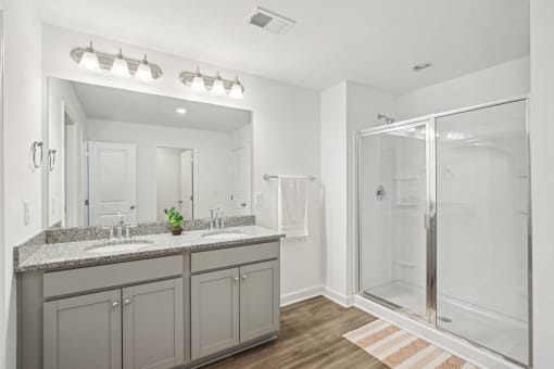 a bathroom with a large mirror and a shower