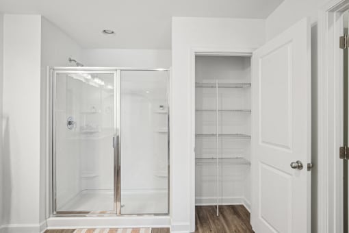 a small bathroom with a shower and a closet