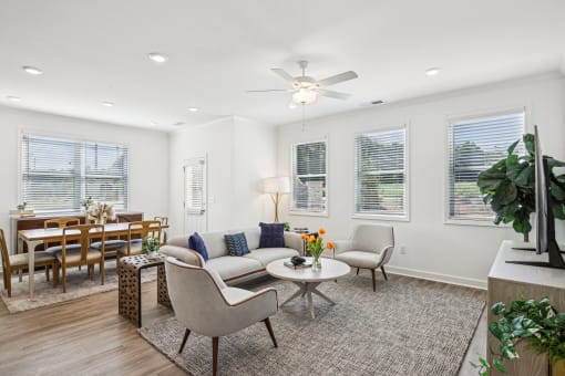 a living room with a couch and chairs