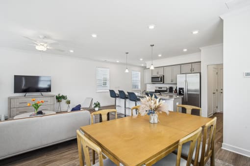 a living room and dining room with a wooden table