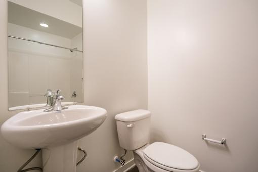 A white sink and toilet in a bathroom.