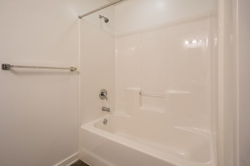 A white bathroom with a bathtub and shower.