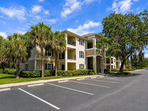 A large building with a parking lot in front of it.
