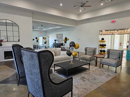 A living room with a grey sofa, a black coffee table, and a fireplace.