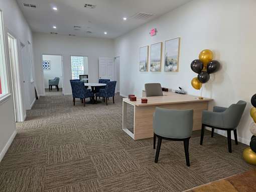 A conference room with a table, chairs, and balloons.
