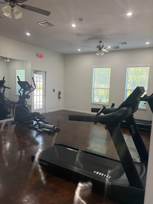 A gym with treadmills and exercise bikes.