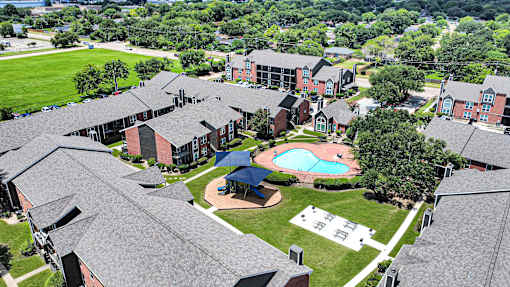 A large building complex with a pool in the middle.