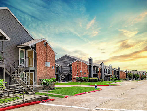 A row of modern houses with a red fire hydrant in the foreground.