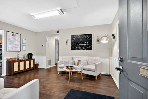A room with a white couch and a chalkboard on the wall.