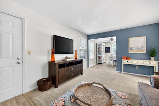 A living room with a flat screen TV and a wooden cabinet.